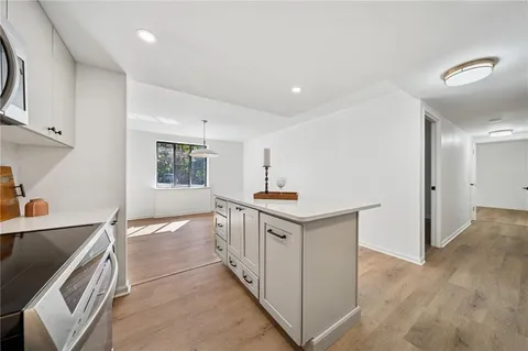 a kitchen with stainless steel appliances granite countertop a sink and cabinets