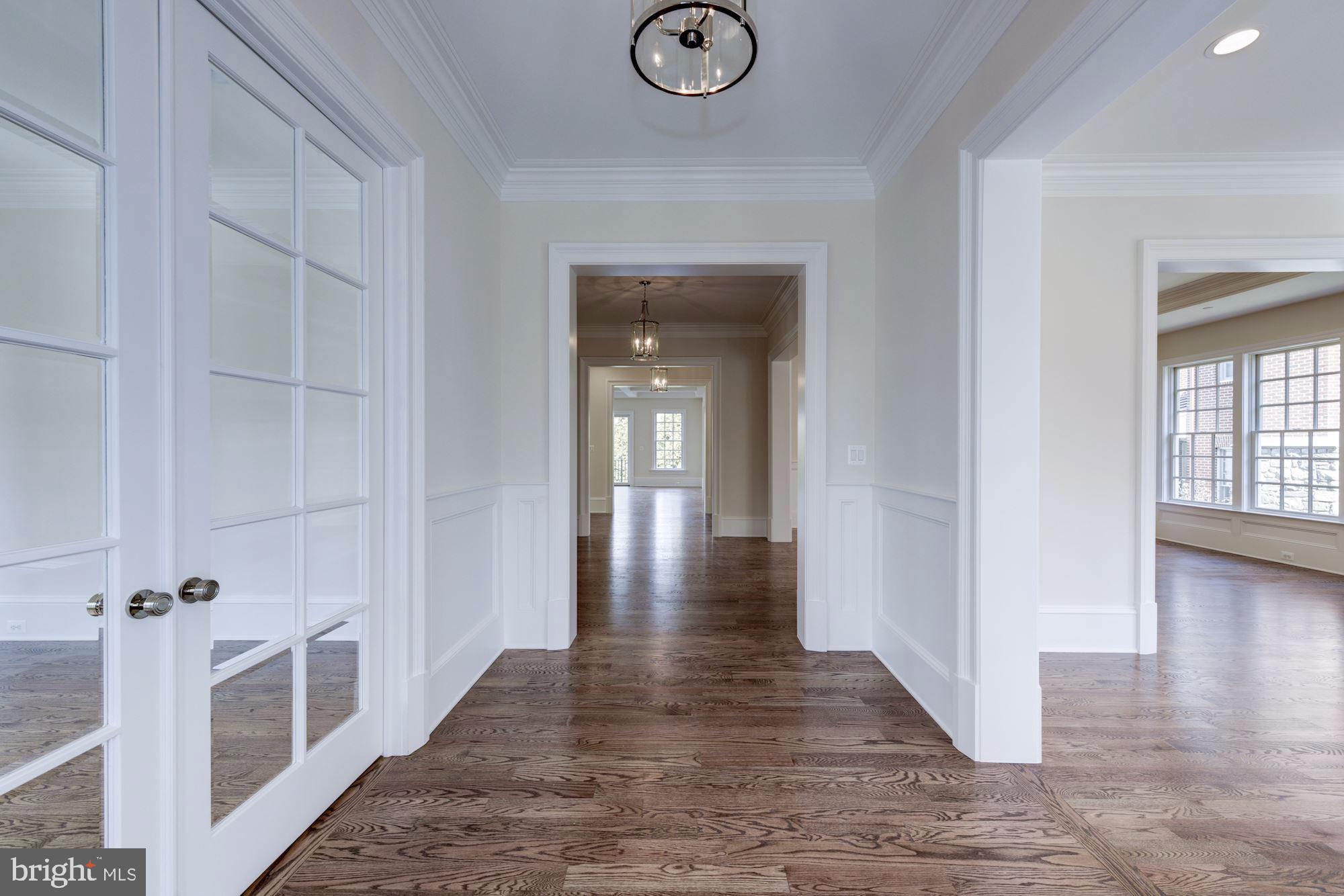 4513 Hoban Road Northwest Washington, DC 20007 - Photo 2 of 29 a view of a hallway with wooden floor and a fireplace
