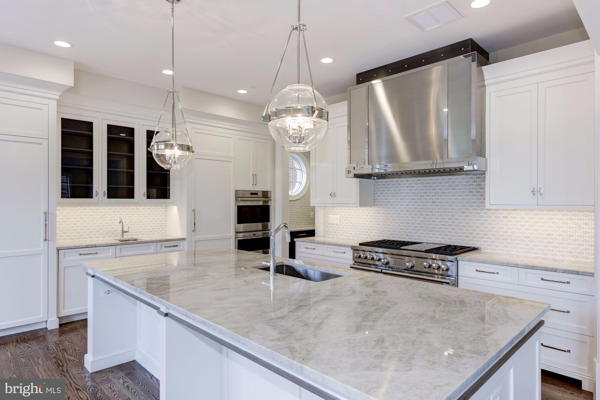 4513 Hoban Road Northwest Washington, DC 20007 - Photo 15 of 29 a kitchen with stainless steel appliances granite countertop a sink a stove and a wooden floors