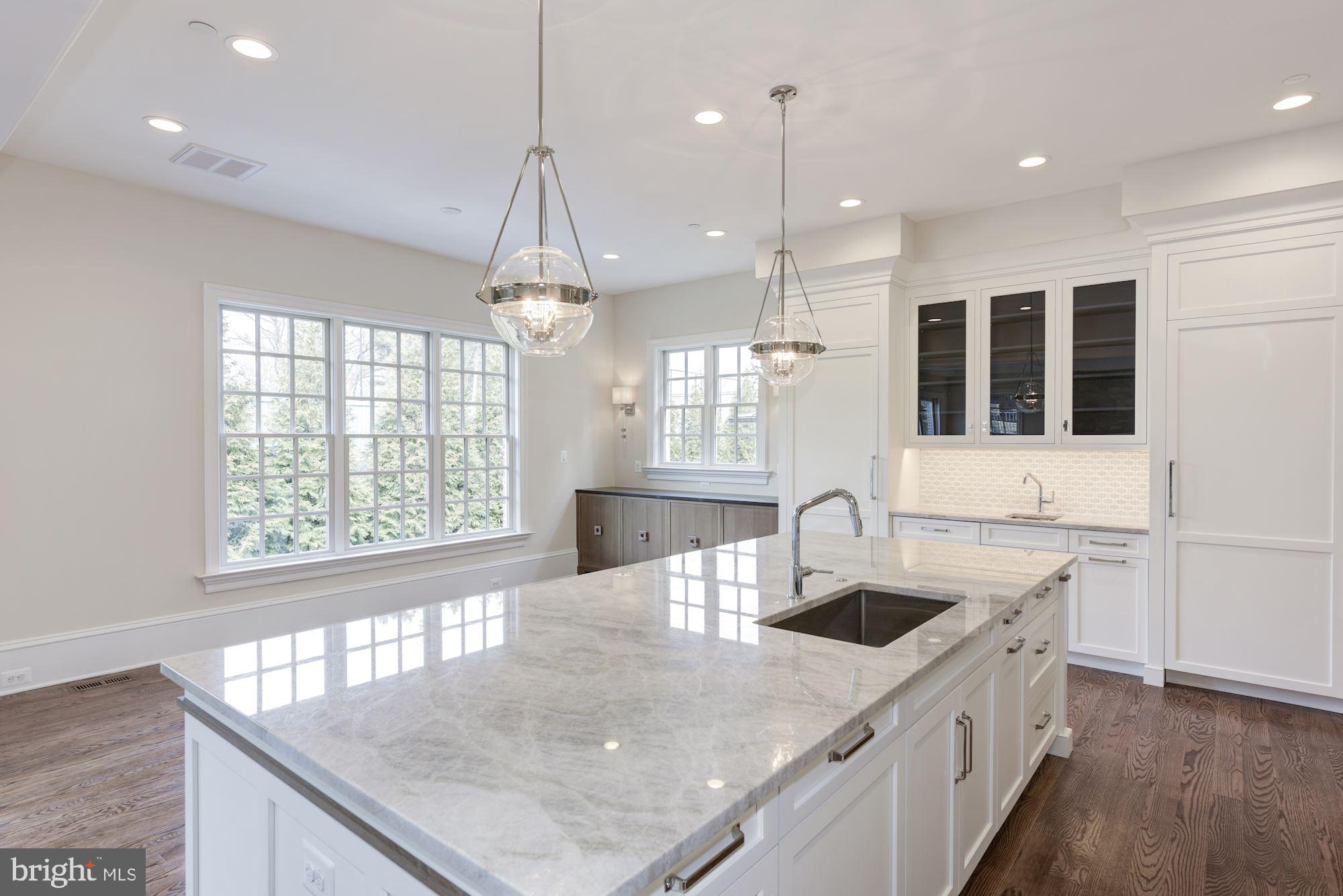 4513 Hoban Road Northwest Washington, DC 20007 - Photo 16 of 29 a kitchen with kitchen island a sink appliances and a counter top space
