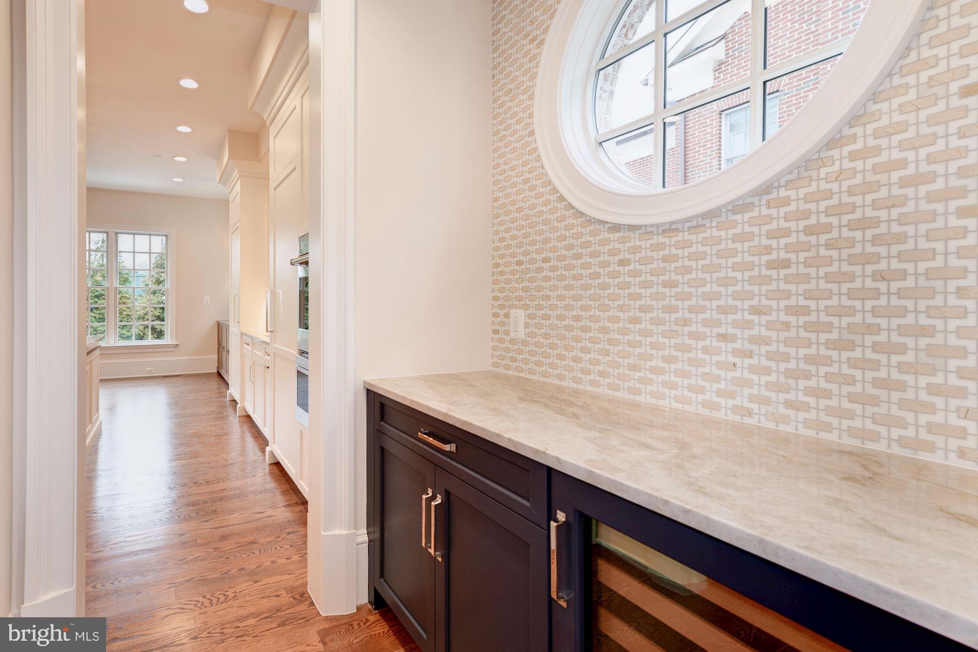 4513 Hoban Road Northwest Washington, DC 20007 - Photo 18 of 29 a hallway with view of wooden floor and a chandelier