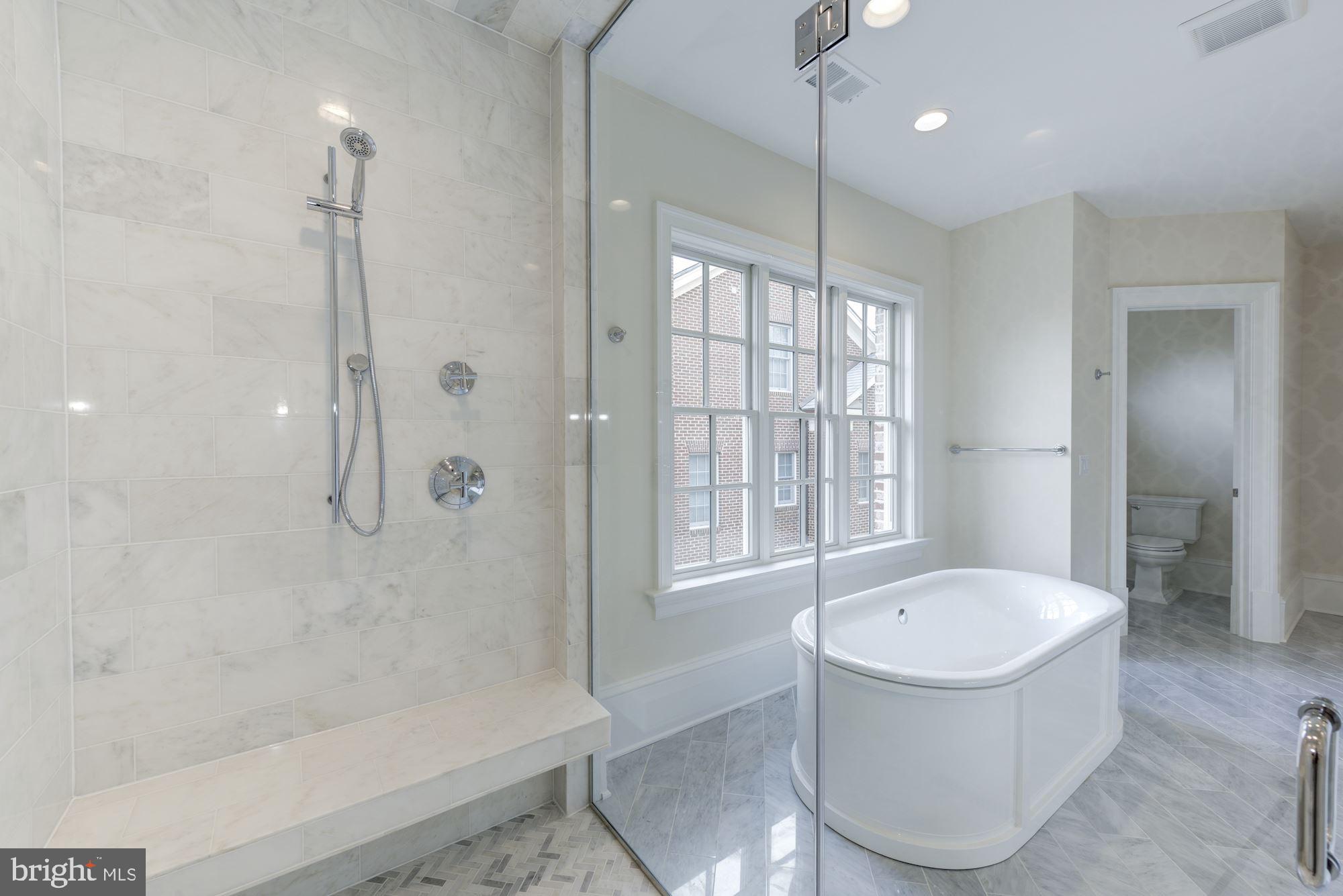 4513 Hoban Road Northwest Washington, DC 20007 - Photo 19 of 29 a bathroom with a tub a window and a shower
