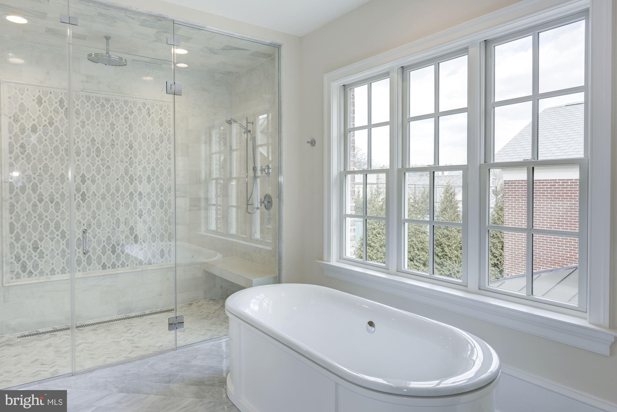 4513 Hoban Road Northwest Washington, DC 20007 - Photo 20 of 29 a white bath tub sitting under a bathroom next to a window