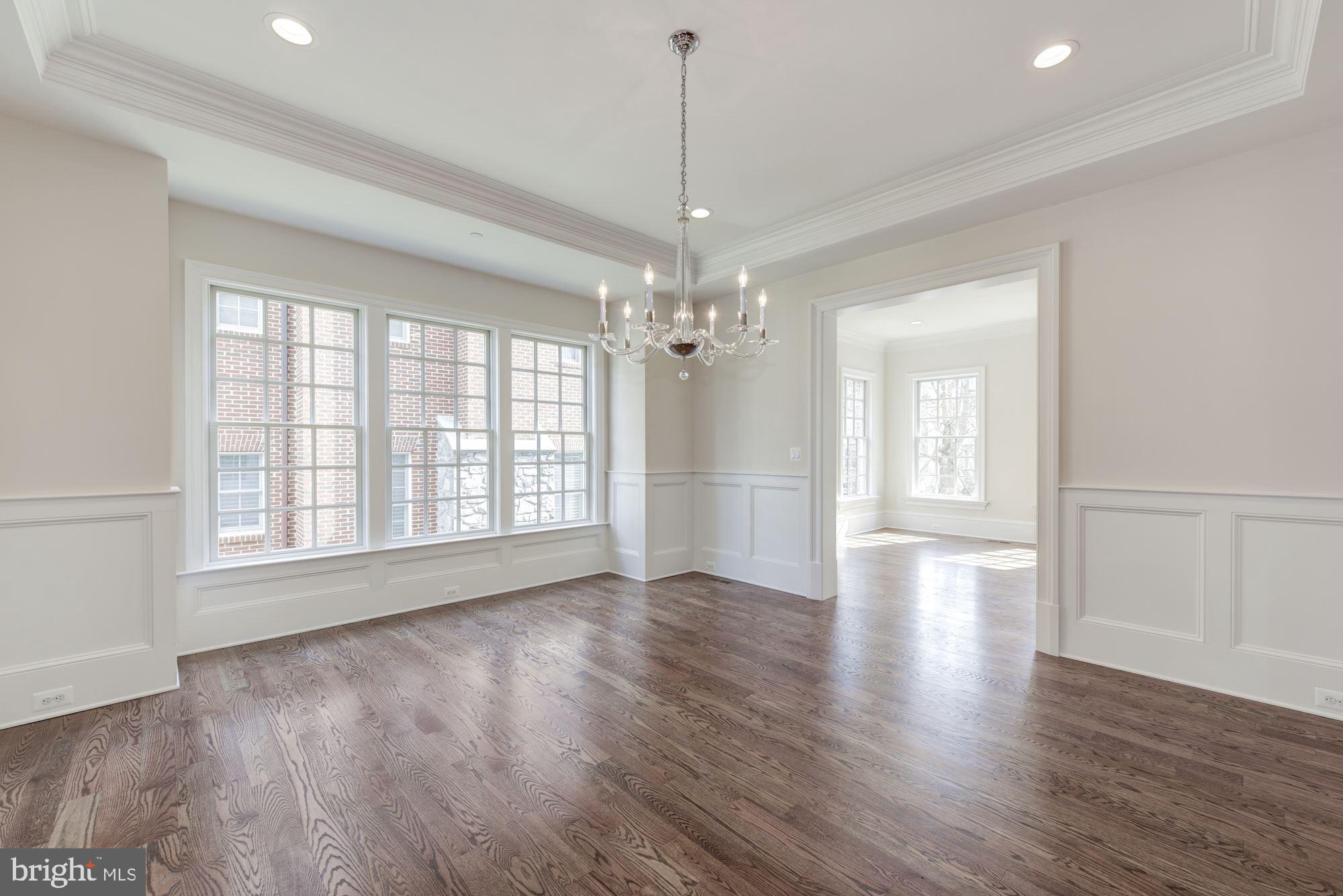 4513 Hoban Road Northwest Washington, DC 20007 - Photo 4 of 29 a view of an empty room with wooden floor and a window