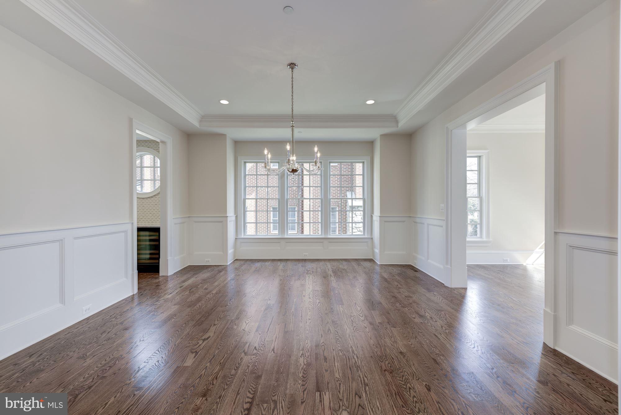 4513 Hoban Road Northwest Washington, DC 20007 - Photo 5 of 29 a view of an empty room with wooden floor and a window