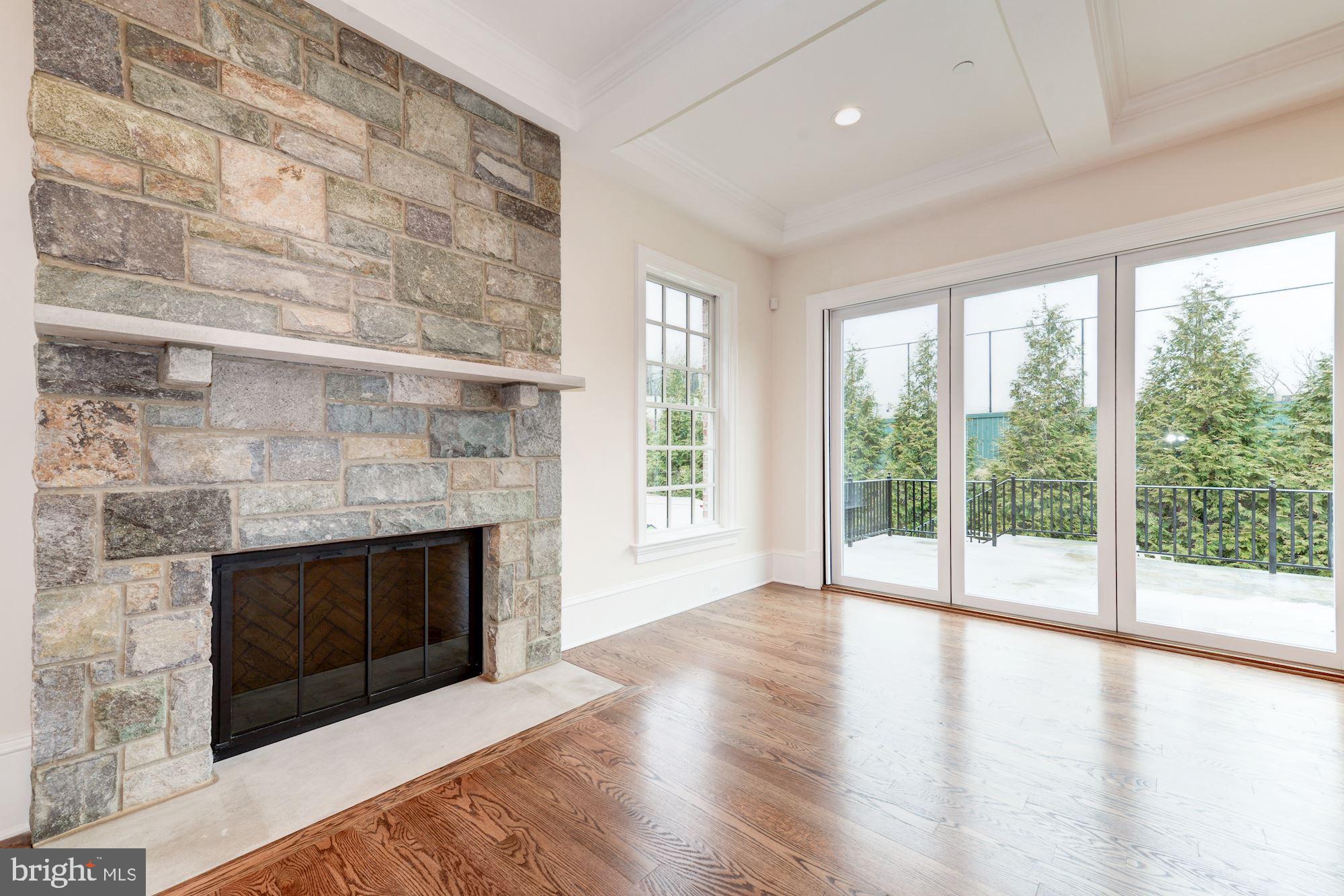 4513 Hoban Road Northwest Washington, DC 20007 - Photo 10 of 29 a living room with a fireplace and a floor to ceiling window