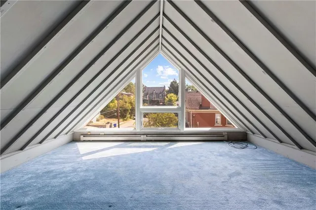 a spacious bedroom with a bed and a window