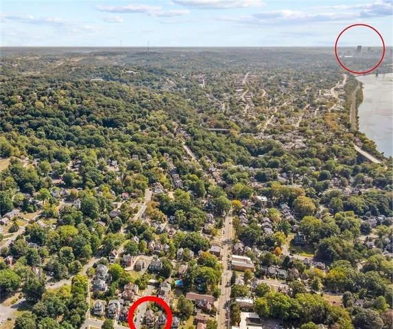 an aerial view of house with yard and mountain view in back