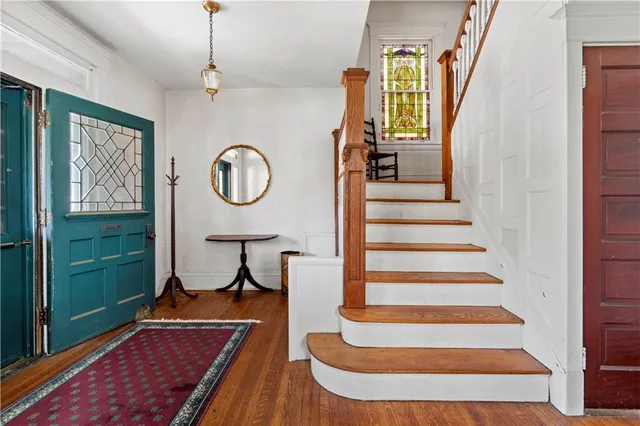 a view of entryway with wooden floor and window