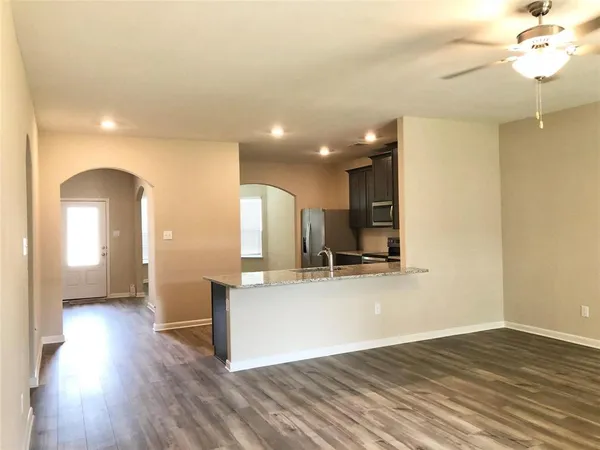 a view of a kitchen with a sink and a refrigerator