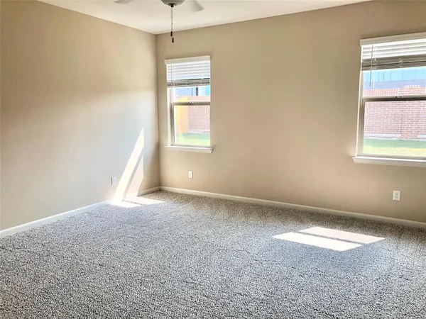 an empty room with windows and closet