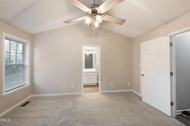 a view of a room with a stylish ceiling fan and entryway