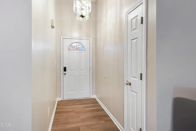 a kitchen with stainless steel appliances white cabinets a sink a stove a refrigerator and cabinets