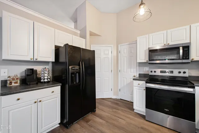 a view of a room with wooden floor and windows