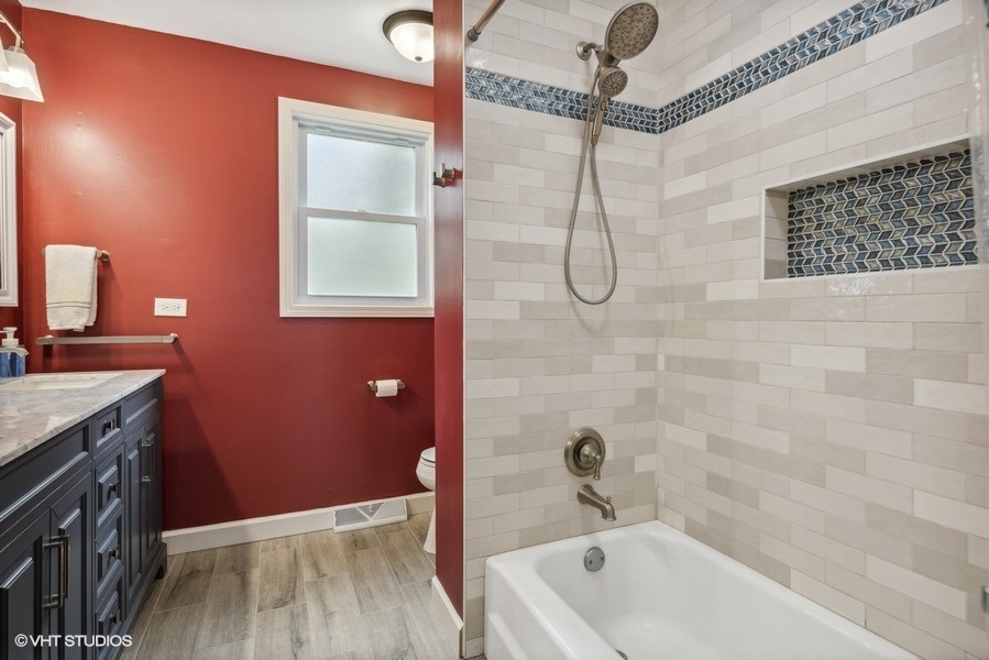 534 71st Street Darien, IL 60561 - Photo 15 of 20 a bathroom with a tub a sink and shower