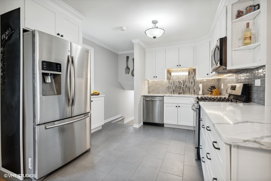 534 71st Street Darien, IL 60561 - Photo 8 of 20 a kitchen with stainless steel appliances a refrigerator sink and cabinets
