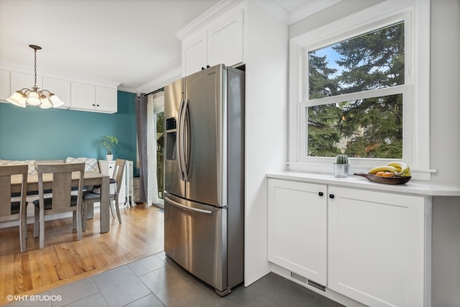 534 71st Street Darien, IL 60561 - Photo 9 of 20 a kitchen with stainless steel appliances granite countertop a refrigerator and a view of living room