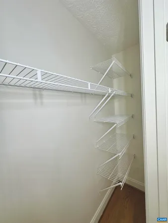 a room with linen closet and wooden floor
