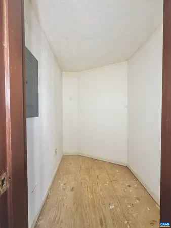 a view of a room with wooden floor and bench