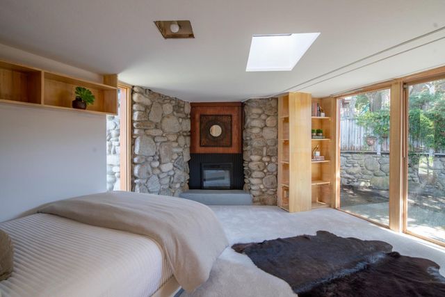 a bedroom with a bed and a large window