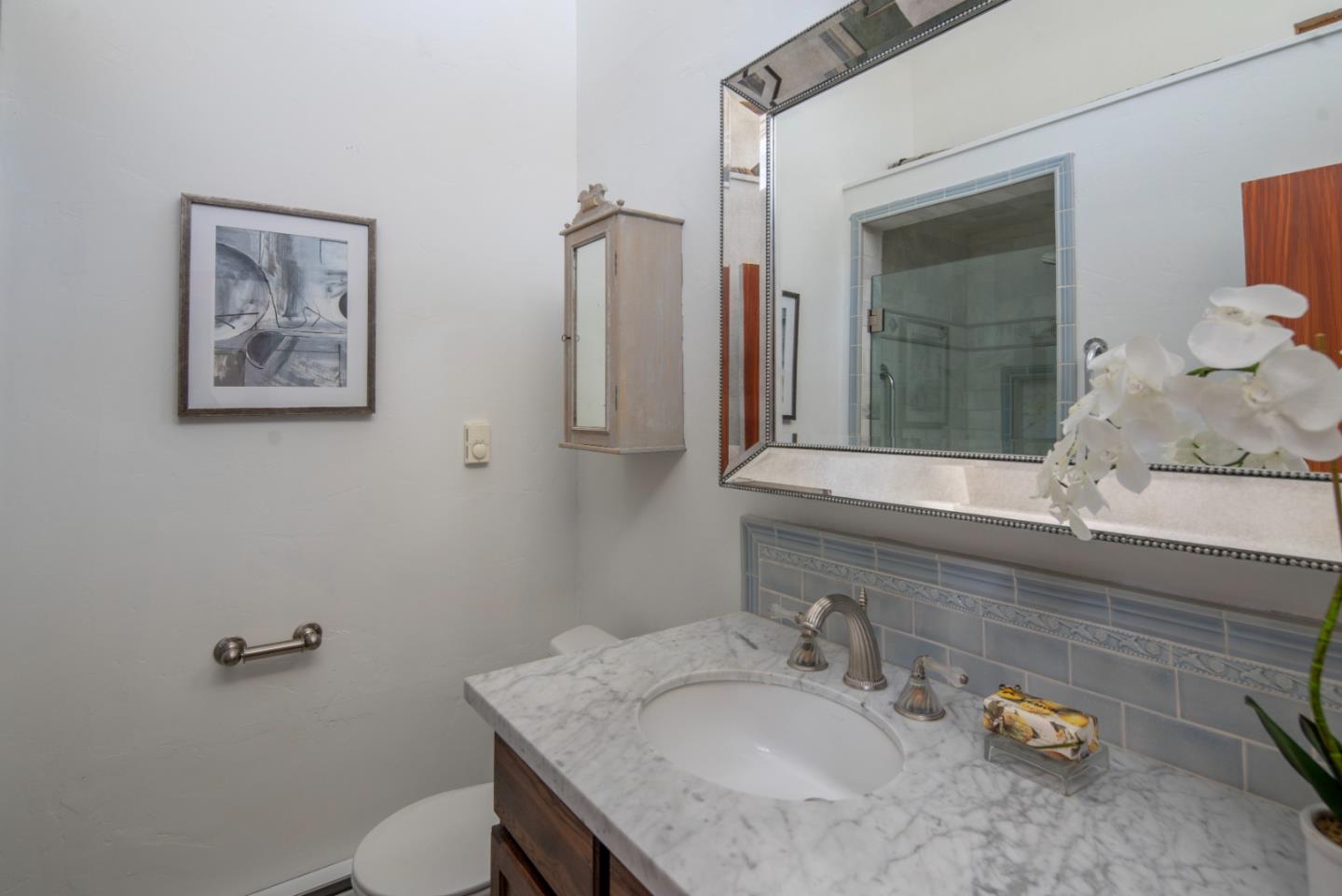5 Yankee Beach Way Carmel, CA 93923 - Photo 16 of 25 a bathroom with a granite countertop sink a toilet and mirror