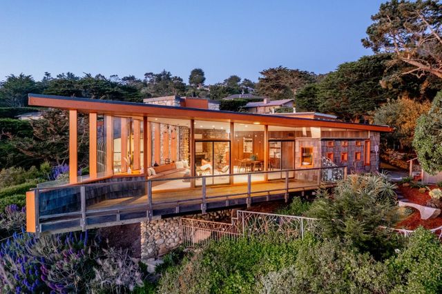 a view of swimming pool with outdoor seating and plants
