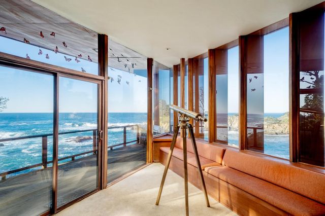 a room with lots of furniture and floor to ceiling window