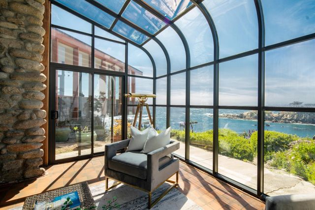 a living room with furniture and a floor to ceiling window