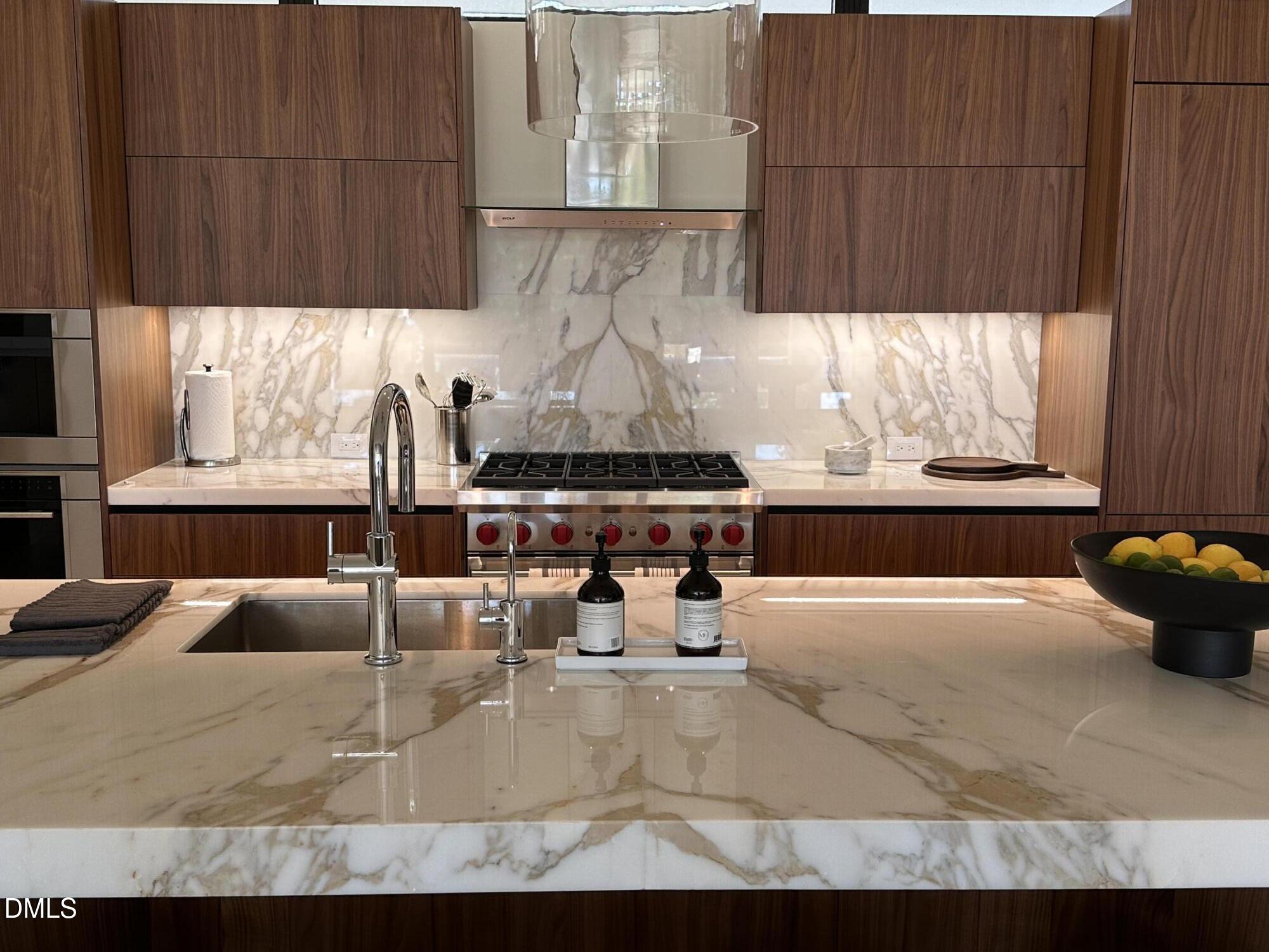 403 Rutherglen Drive Cary, NC 27511 - Photo 18 of 27 a kitchen with stainless steel appliances kitchen island granite countertop a sink and cabinets