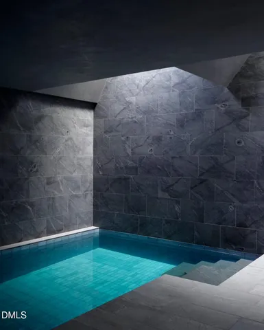 a view of a house with a lush green forest