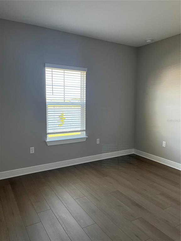3012 Polaris Drive St. Cloud, FL 34771 - Photo 12 of 21 an empty room with wooden floor and windows