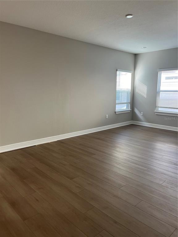 3012 Polaris Drive St. Cloud, FL 34771 - Photo 13 of 21 a view of an empty room with wooden floor and window