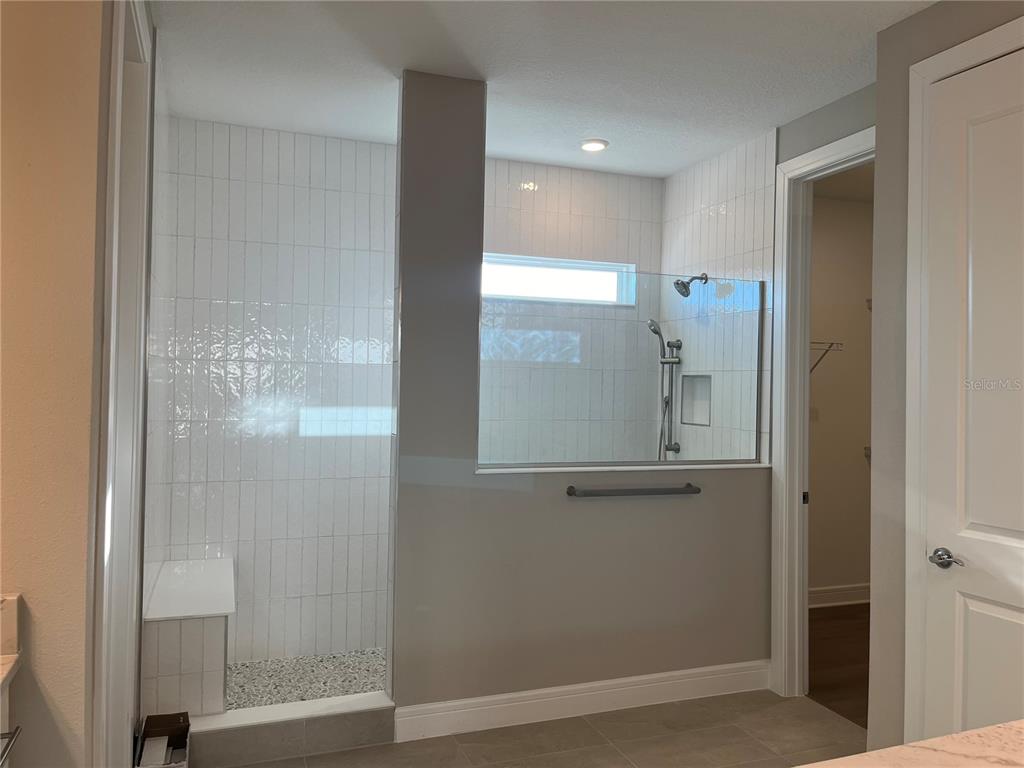 3012 Polaris Drive St. Cloud, FL 34771 - Photo 15 of 21 a bathroom with a glass shower door