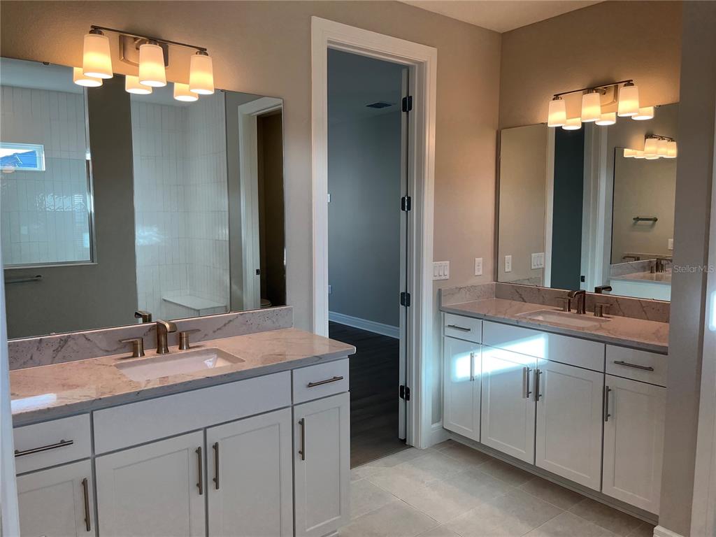 3012 Polaris Drive St. Cloud, FL 34771 - Photo 16 of 21 a bathroom with a double vanity sink and a mirror
