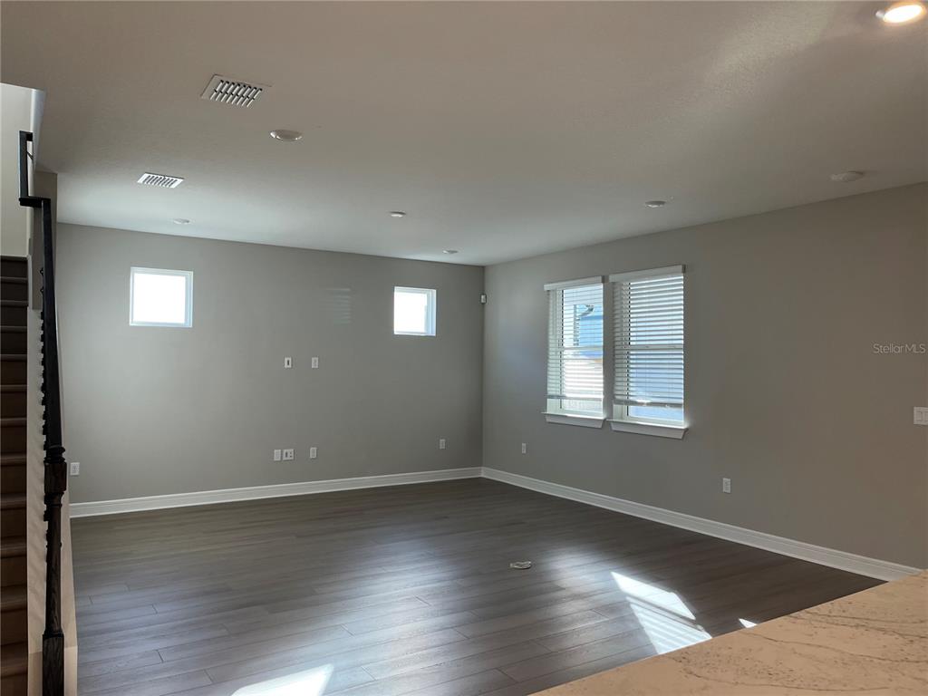 3012 Polaris Drive St. Cloud, FL 34771 - Photo 9 of 21 an empty room with wooden floor and windows