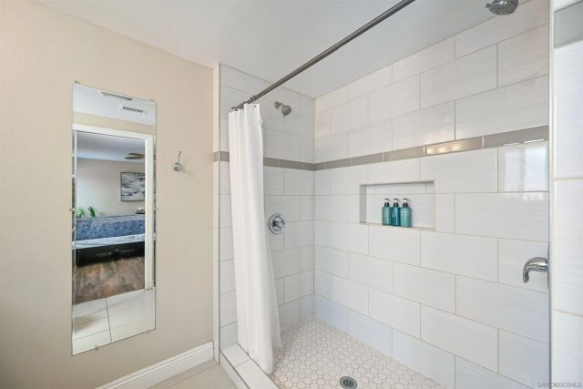 a bathroom with a shower and a sink