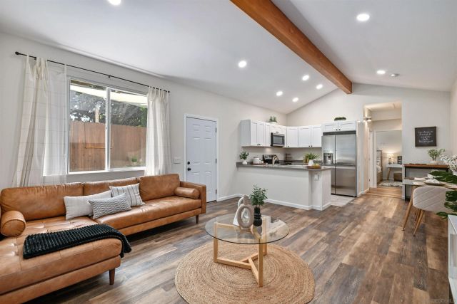 a living room kitchen with a couch and kitchen view