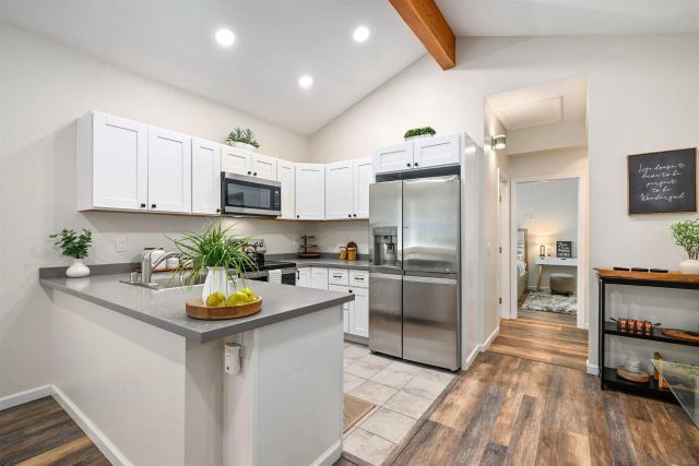 a kitchen with sink a stove and cabinets