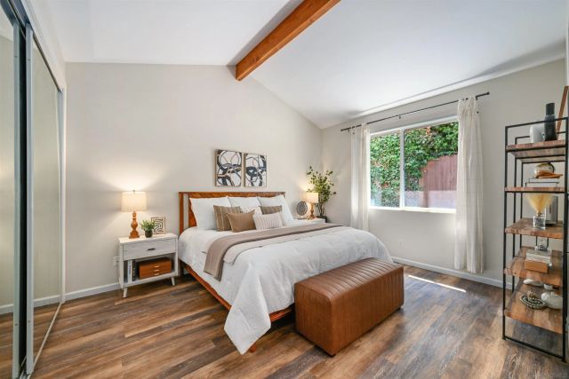 a bedroom with a bed and a large window