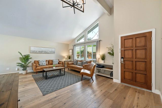 a living room with furniture window and wooden floor