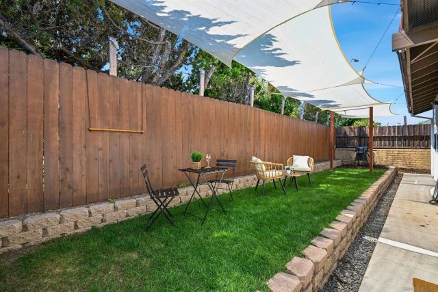 a view of a backyard with wooden fence