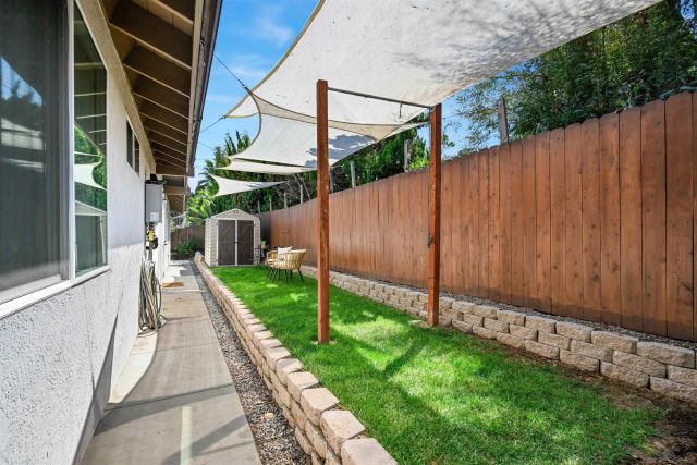 a patio with patio a table and chairs under an umbrella