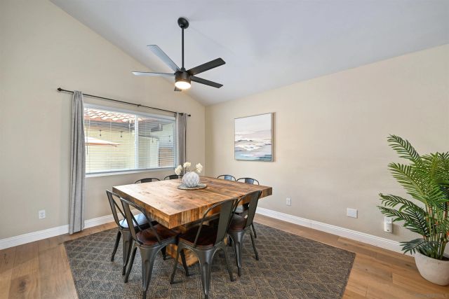 a view of a dining room with a table and chairs