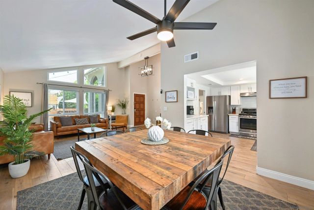 a dining room with furniture and wooden floor