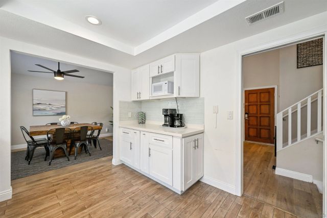 a kitchen with cabinets table and chairs