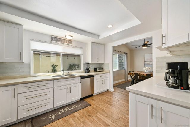 a kitchen with sink cabinets and wooden floor