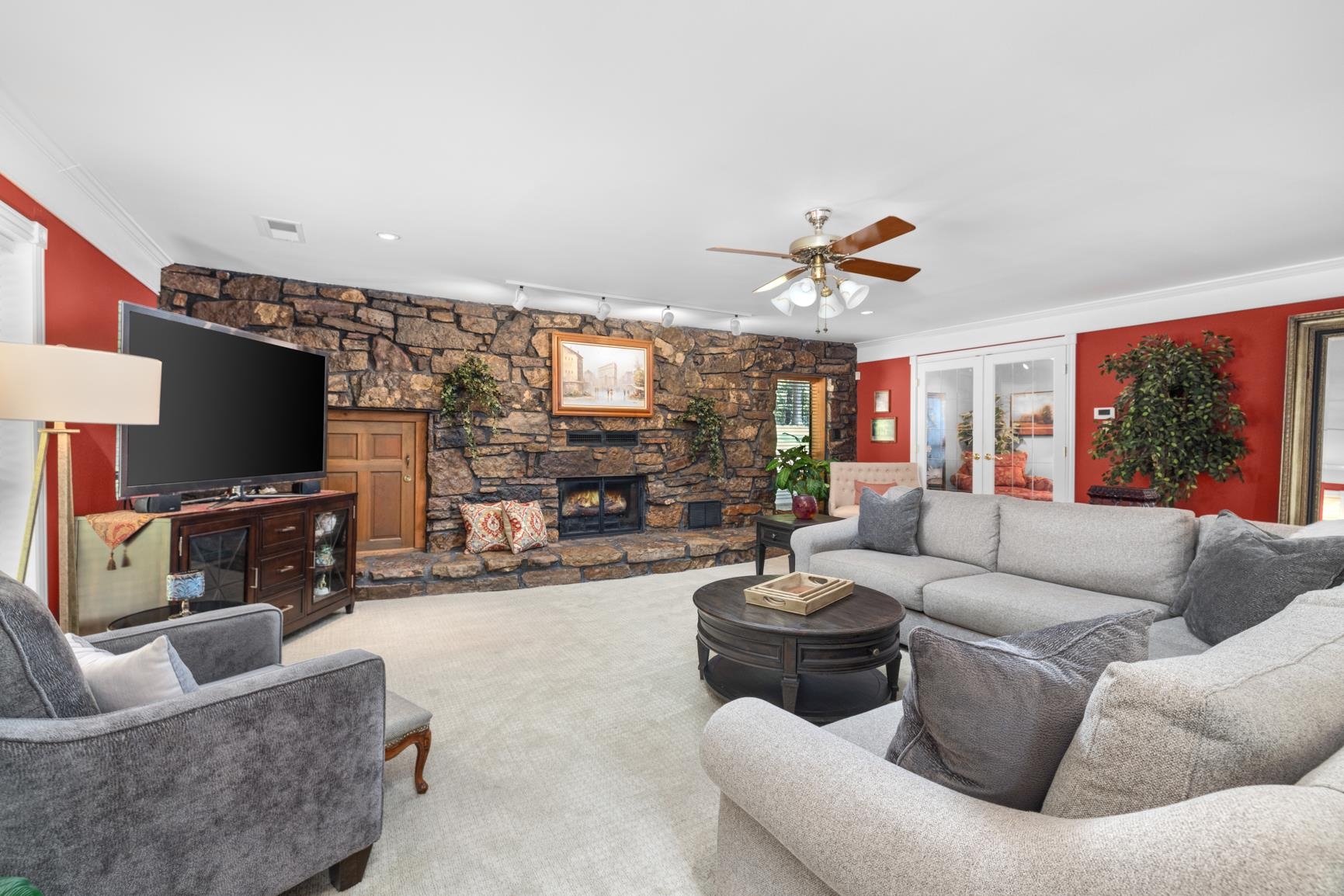 120 Blueberry Road Eads, TN 38028 - Photo 9 of 40 A wall to wall Arkansas stone hearth with gas fireplace is an eye catcher in this oversized den with doors to the backyard and a reading room. Don't forget to look in the wood box, a cute children's reading nook awaits them!