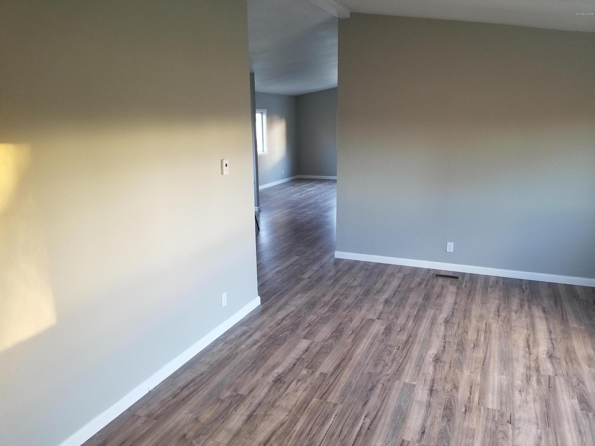 1033 Rader Road Sunnyside, WA 98944 - Photo 3 of 12 a view of a small space with wooden floor and a window