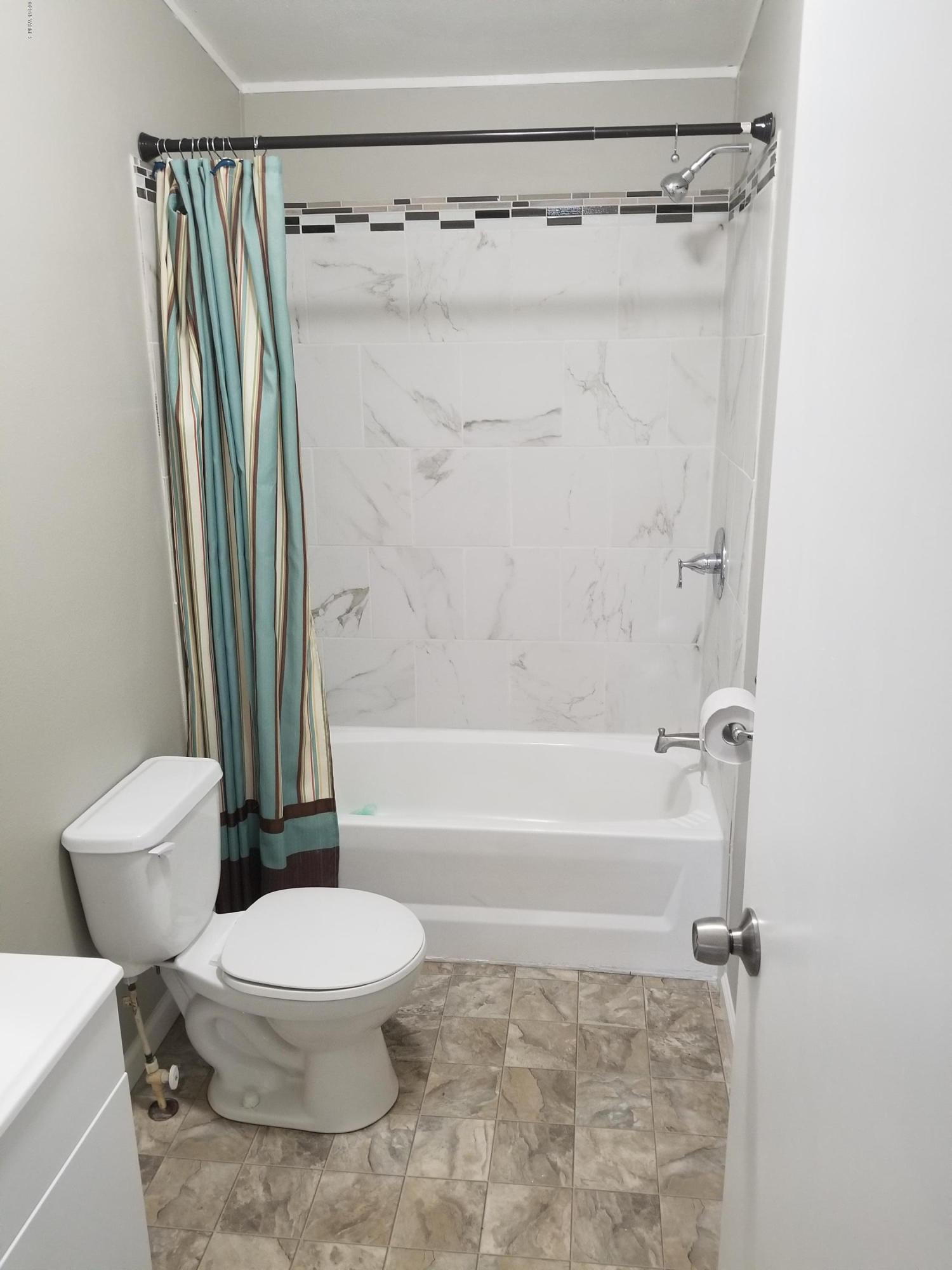 1033 Rader Road Sunnyside, WA 98944 - Photo 7 of 12 a bathroom with a toilet and a shower