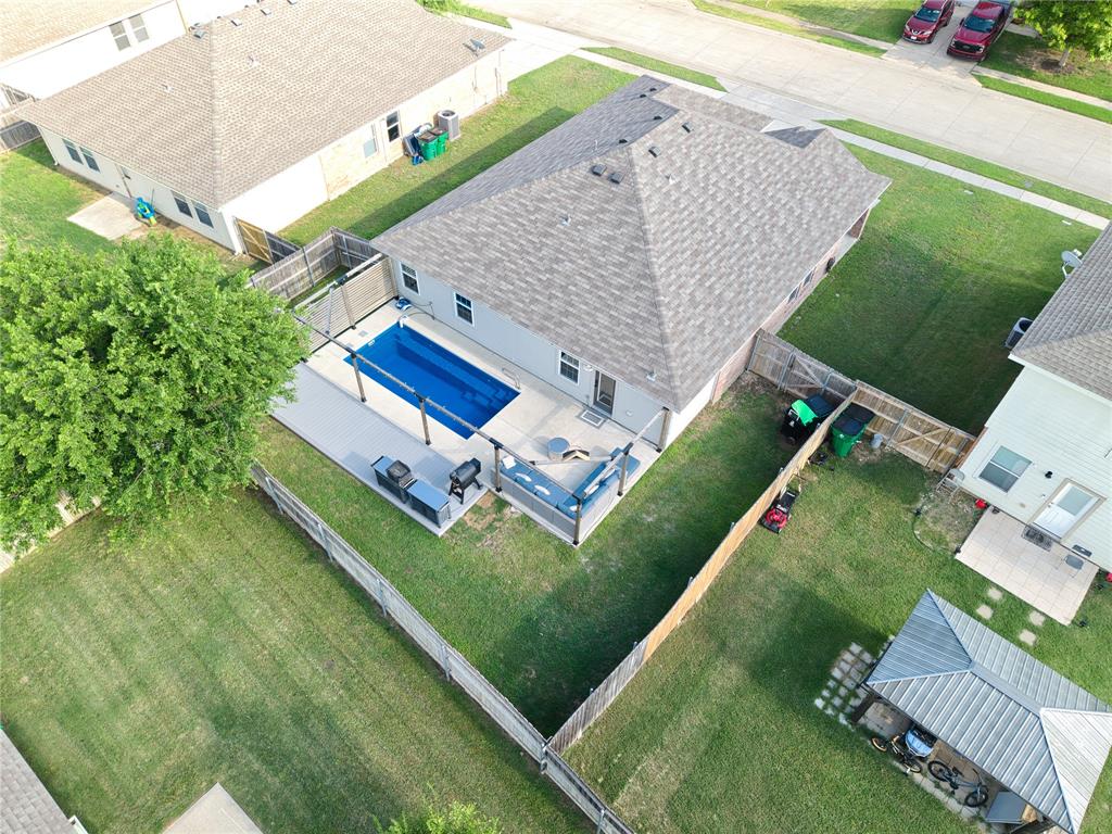 12724 Carpenter Lane Rhome, TX 76078 - Photo 35 of 37 Rear exterior featuring a fenced yard, inground swimming pool with cover, and an expansive concrete patio